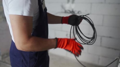 Electrician Handles Cable Wire Indoors