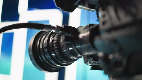 Close Up Cinema Lens Reflecting Blue Green Studio Lights with Optics Detail