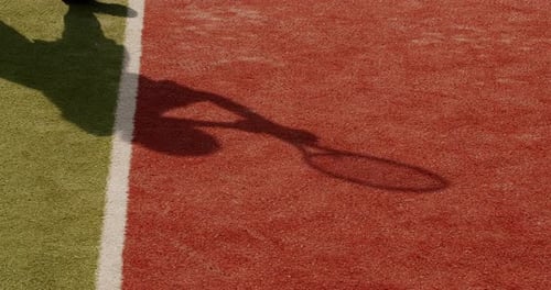 Shadow of Tennis Player Hitting Ball on Court