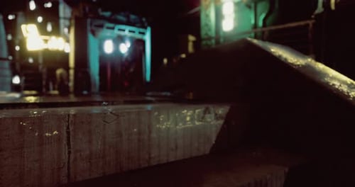 Urban Night Scene with Wet Surfaces and Lights in an Industrial Area