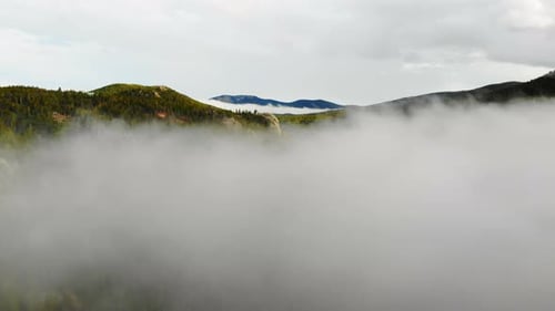 Low Clouds And Fog Over Colorful Rocky Mountain Alpine Valley