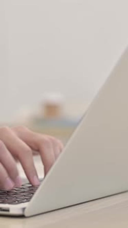 Hands Typing on Laptop in Bright Indoor Setting
