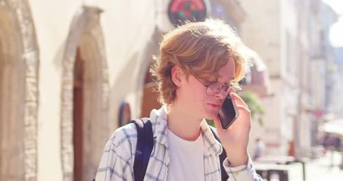 Cheerful Caucasian Male Teenager Talking to Family on Cellphone in City Young Man Guy Wearing Casual