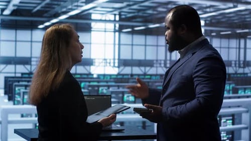 Teamworking Colleagues in Data Center Replacing Storage Rackmounts Components