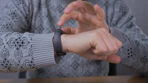 Male Person Using Smart Watch Display in Office