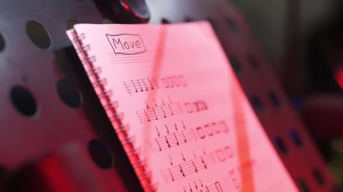 Music Sheets Notebook on Perforated Stand in Studio Closeup