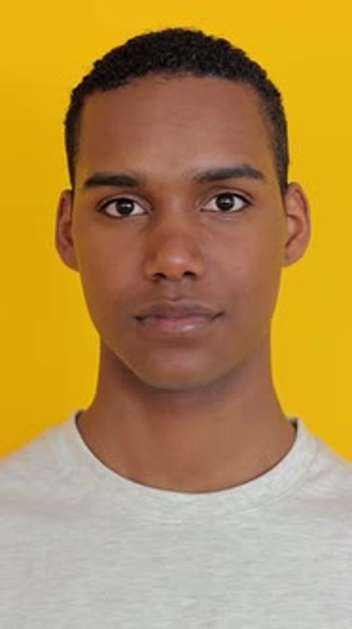 Smiling Young Adult Portrait Against Yellow Background