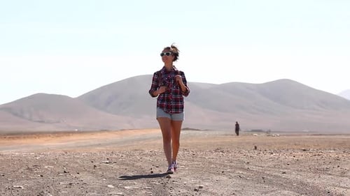 Happy woman walking in the desert in Fuerteventura