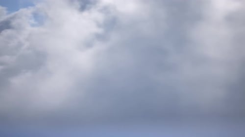 Time-lapse Clouds Moving Across Blue Sky Background