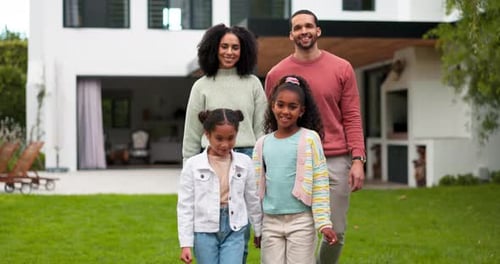 Happy Family Walking Together on the Lawn