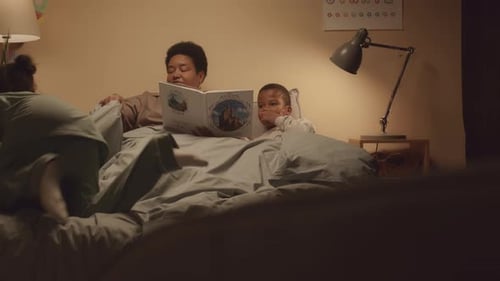 Woman Reading Bedtime Story to Children