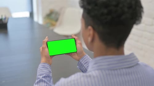 African Woman Holding Horizontal Green Screen Smartphone