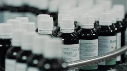 Pharmaceutical Bottles Moving on Conveyor Belt