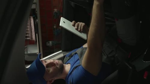 Man Using Tablet for Repairs Indoors