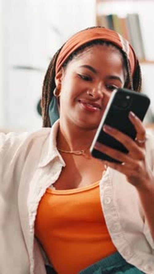 Smiling Woman Using Smartphone Indoors