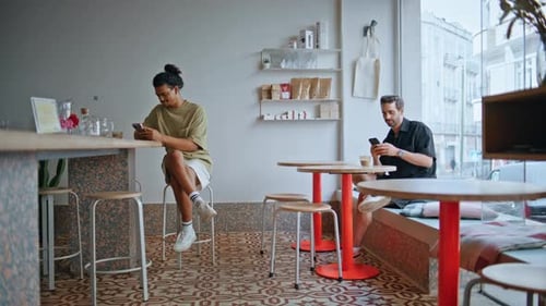 Two Men Sitting Coffeehouse Interior with Smartphones Visitors Relaxing in Cafe