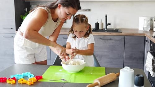 Mother and Child Baking Cookies Together at Home