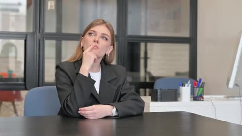 Woman Thinking at Office Desk