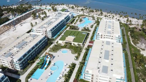 Luxurious hotel resort courtyard with swimming pools and waterslides.