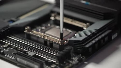 Closeup Cropped Shot of Unrecognizable Professional Repairman in Gloves Screwing in PC CPU Air