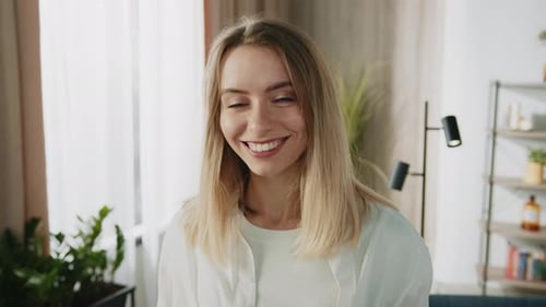 Smiling Woman in White Shirt Poses Indoors
