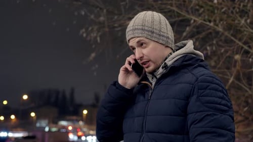 Man Talking on Phone on Cold Urban Night