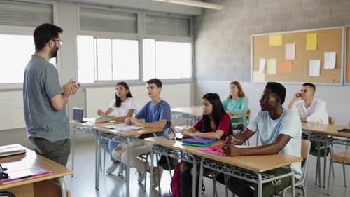 Male Teacher Explaining Lesson to High School Students in Classroom