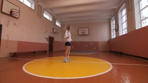 Young Girl Woman Jumping Rope in School Gym
