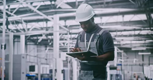 Technician Wearing Safety Helmet Controls Production Processes