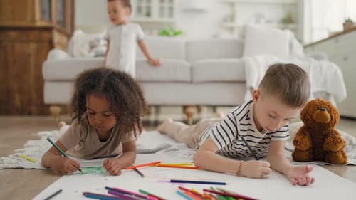 Children Drawing Together on Paper Indoors