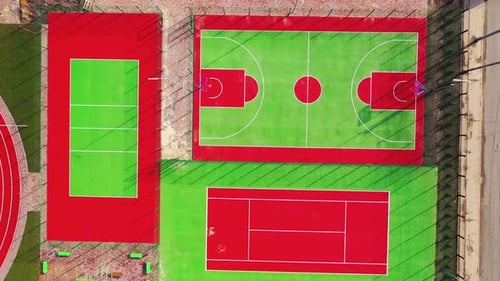 Sports complex outdoors. Green and red artificial grass on fields for doing sport.