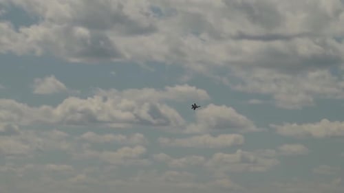 Military Jet Performs Aerial Maneuvers in Cloudy Sky