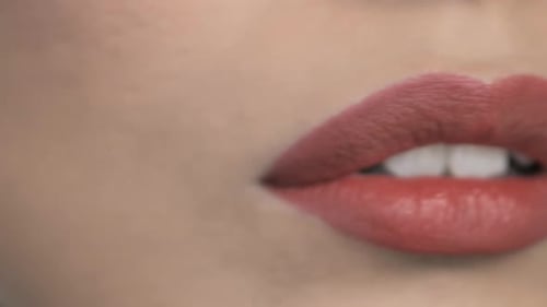 Extreme Close Up of Woman Applying Lipstick