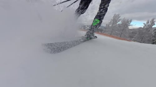 Close Up View of Professional Ski Boots and Skis Carving Through Snow Action Winter Sport