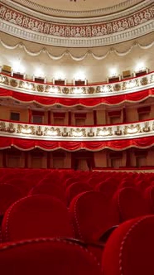 Rows with red chairs in beautiful theater hall. No audience at lockdown time.