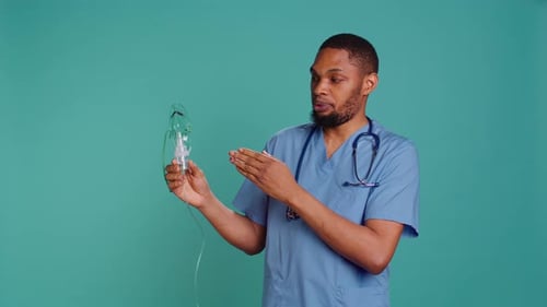 Nurse Holding Handheld Nebulizer Used for Delivering Aerosols