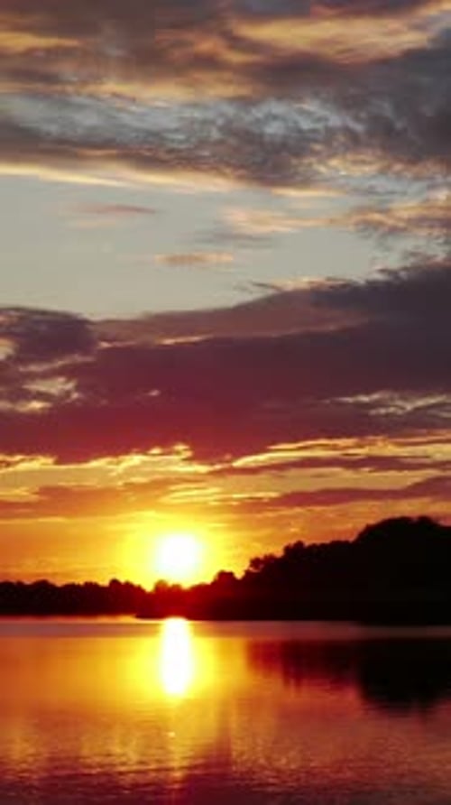 Radiant Sunset Over Still Lake Waters