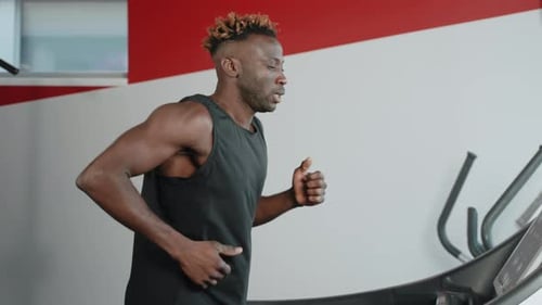 African American Sportsman Having a Cardio Workout on Treadmill