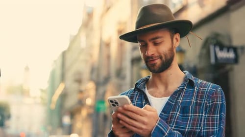 Handsome Tourist Wearing Hat Standing Using Smartphone Outsite Good Looking Male in Old City Street