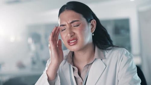 Woman Suffering Headache Pain in Clinical Setting