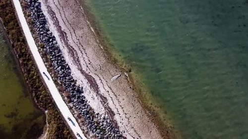 Aerial rotational view of the top of the sea with the beach, sunny nature, sunshine