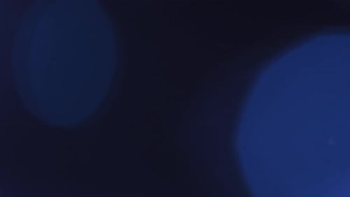 Abstract Overlay with Faded Blue Light Transition Over Top Lens Flare Blended on Dark Background