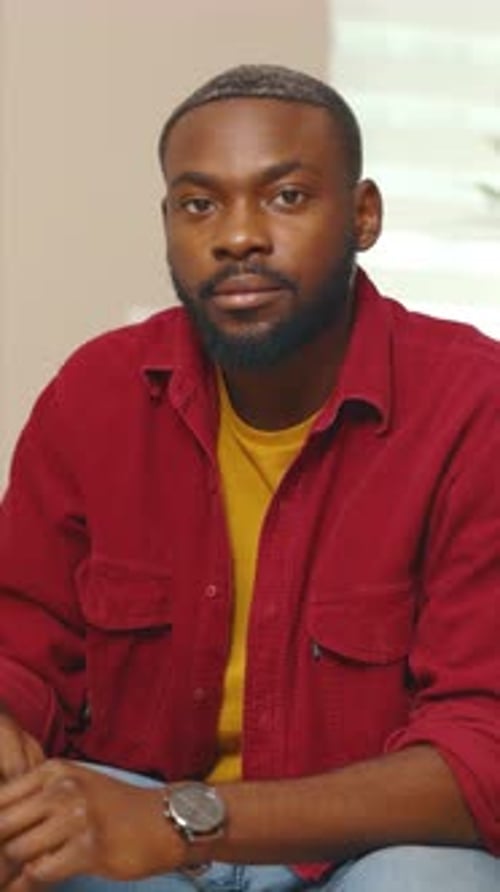 Close Up African American Young Man Using Laptop Look at Camera Serious During Working at Home