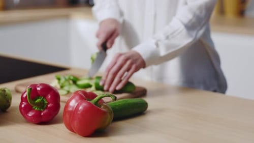 Woman Cutting Vegetables in Bright Modern Kitchen