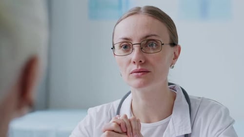 Female Doctor Discussing Health Condition and Treatment with Patient in Clinic