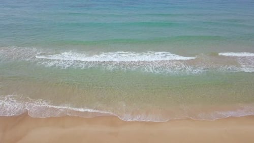 Beautiful empty beach with small waves - Aerial footage.