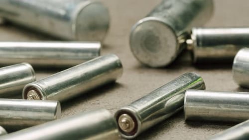 Scattered Used Silver AA Batteries Close Up