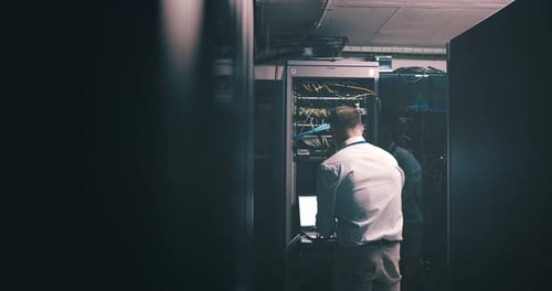 Man, server room and computer for maintenance, system solution and data center