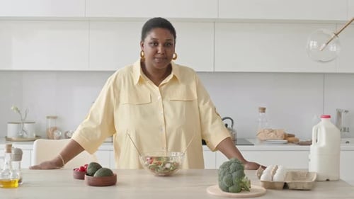 Woman Prepares Healthy Meal in Modern Kitchen