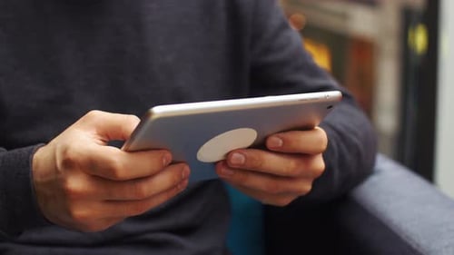 Man Holds Tablet Device Indoors, Close Up